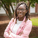 Headshot of Takia Woods outdoors.