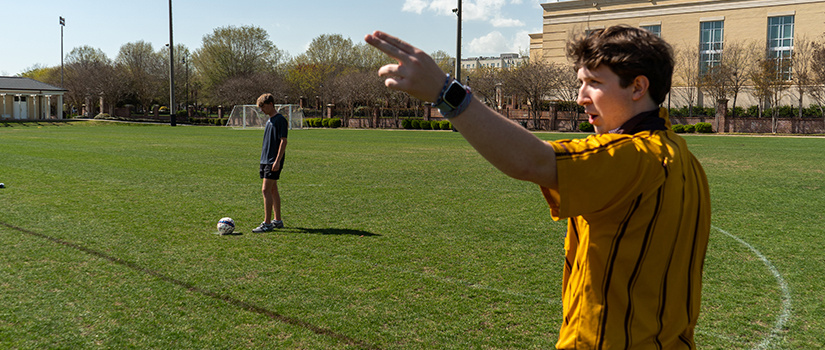 Sport Programs Official refereeing a soccer game.