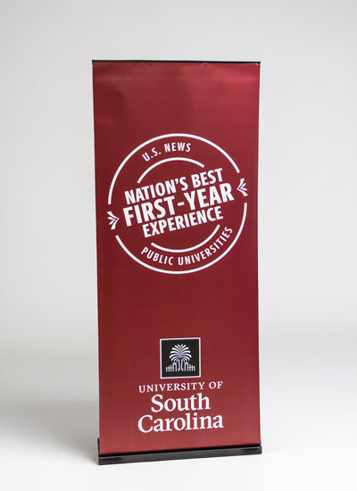 Pop up banner with the USC stamp with text Nation's Best First Year Experience and the University of South Carolina logo on a garnet background.