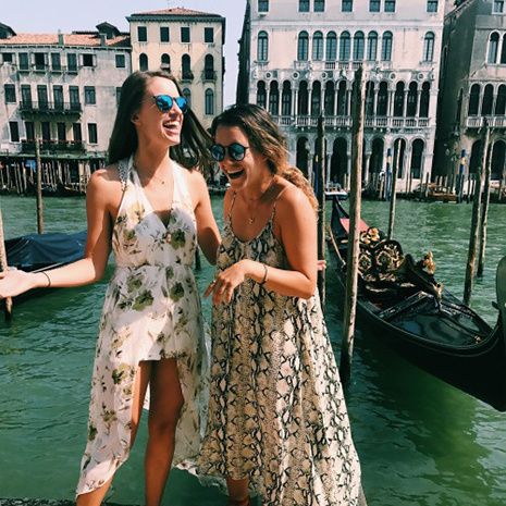 two students standing on a canal in Venice, Italy two students standing on a canal in Venice, Italy