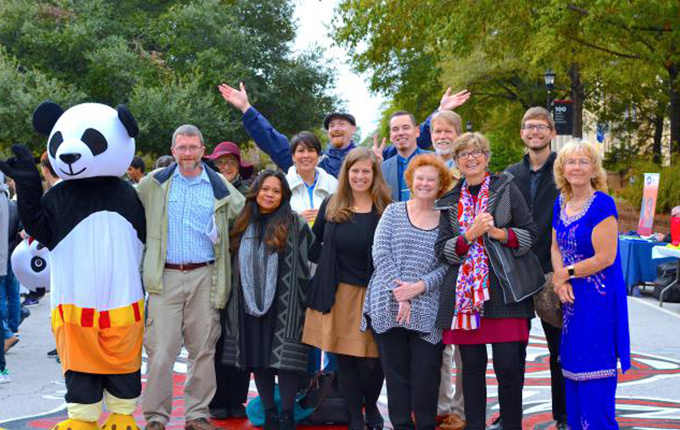 EPI Faculty and Staff celebrating International Education Week outdoors with a large panda.
