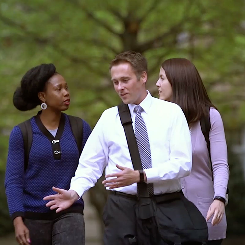Group of employees walking together outside.