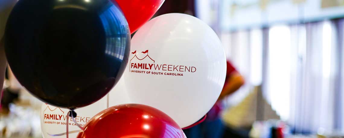 Garnet, black and white balloons with family Weekend logo