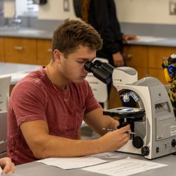 Boy looking through microscope